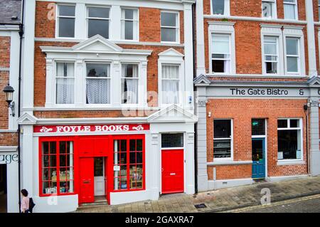 Londonderry, Northern Ireland, July, 2016. The shops along the street near Derry City Wall. Stock Photo