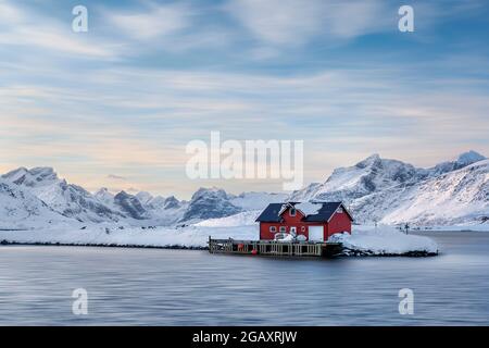Red Fishing Shack in winter, Ramberg, Flakstad Municipality, Nordland county, Norway Stock Photo