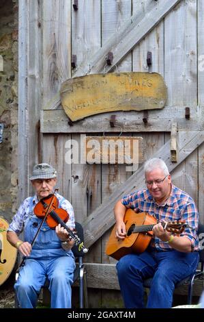 Omagh, County Tyrone, Northern Ireland, Sep., 2017. Two men perform instruments at Ulster American Folk Park. Stock Photo