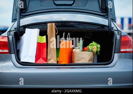 Car with cardboard bags in opened trunk Stock Photo