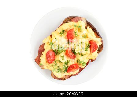 Scrambled eggs with microgreen and tomatoes on bread isolated on a white background. Top view, flat lay Stock Photo