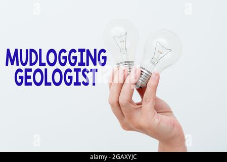Handwriting text Mudlogging Geologist, Business overview gather information and creating a detailed well log Hand holding two lamp showing or presenti Stock Photo