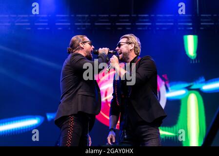 Keith Duffy and Brian McFadden of Boyzlife performing at Fantasia music festival in Maldon, Essex, UK. Singing together Stock Photo