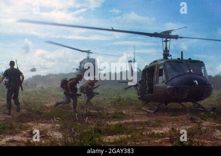 NEAR CU CHI, VIETNAM - 16 May 1966 - UH-1D helicopters airlift members of the US Army 2nd Battalion, 14th Infantry Regiment from the Filhol Rubber Pla Stock Photo