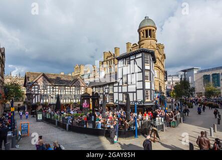 The half-timbered Old Wellington Inn and Sinclair's Oyster Bar in Shambles Square, central Manchester, north-west England, crowded with outdoor diners