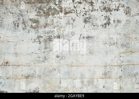 Old white cement wall with worn out plaster Stock Photo