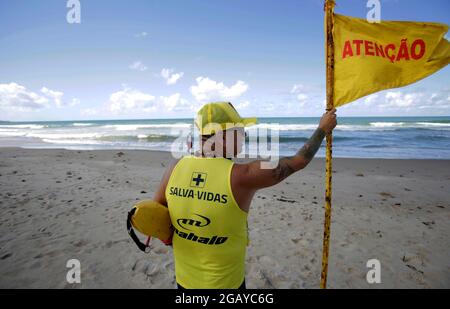 salvador, bahia, brazil - june 26, 2019: Lifeguards observe ocean waves moving on a beach in Salvador city. Stock Photo