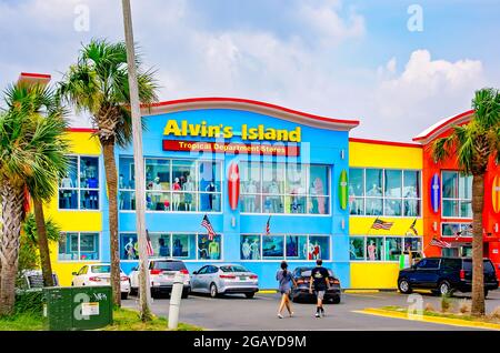 People walk across the parking lot at Alvin’s Island surf company and souvenir shop, July 31, 2021, in Gulf Shores, Alabama. Alvin’s Island owns 32 st Stock Photo