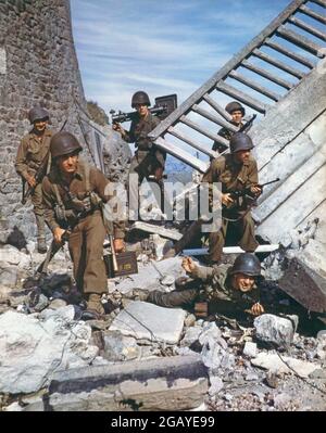 World War Two WWII second world war color colour American soldiers in the field of battle amongst ruins Stock Photo