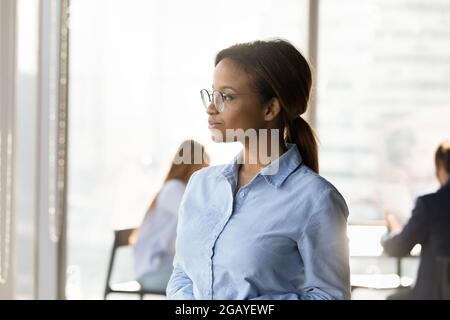 Pensive young african woman looking in distance. Stock Photo