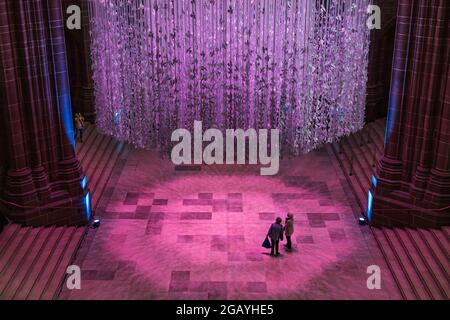 Senior women looking up at the Peace Doves in Liverpool Cathedral in July 2021.  Approximately 18000 paper doves can be seen hanging from 15.5 meter r Stock Photo