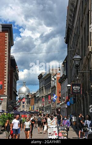 Montreal, Canada - July 31, 2021: Crowd of people walk along the street Rue Saint-Paul E in old Montreal during the long weekend. Stock Photo