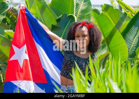 Afro woman with a Cuban flag outdoors Stock Photo