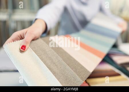 Colorful fabric catalog on seamstress or dressmaker work table Stock Photo