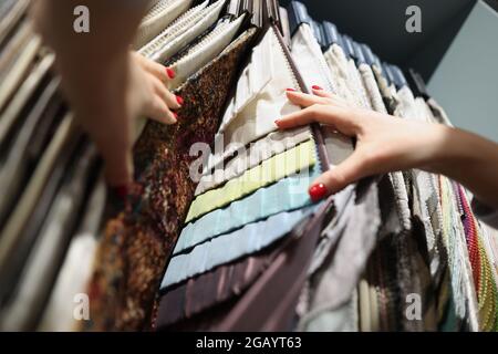 Multi-colored fabrics on exhibition stand in store Stock Photo