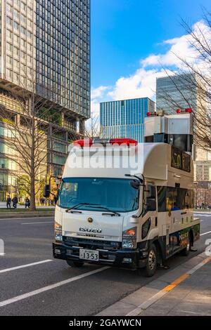 tokyo, japan - january 02 2021: Japanese sign car by Isuzu used in transportation corps of Metropolitan Police Department mounted on hydraulic jack li Stock Photo