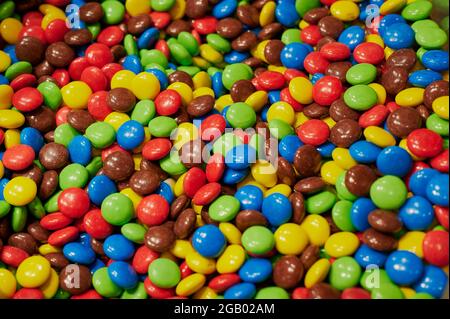 multicolored chocolate lentils background photo Stock Photo