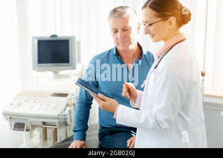 Doctor woman explaining patient test results after examination Stock Photo