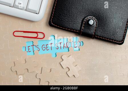 Text sign showing Let S Is Get Started. Business concept to begin doing or working on something you had started Building An Unfinished White Jigsaw Stock Photo