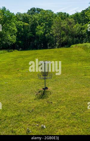 A disc golf goal patiently awaits disc golfers. Stock Photo