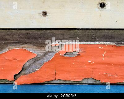 Peeling paint on weathered old wood abstract Stock Photo
