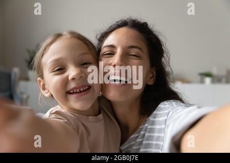 Selfie of happy young mom and sweet little daughter Stock Photo