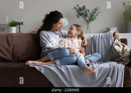 Happy mom enjoying leisure time with daughter kid at home Stock Photo