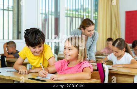 Kid cheating during test Stock Photo