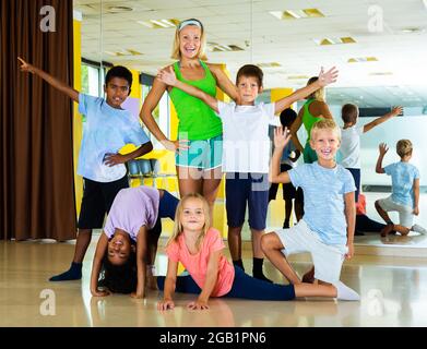 Fun Lesson Picture Happy children and their female teacher having fun together during ...