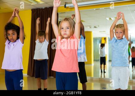 Portrait of smiling children practicing sport dance in modern dance hall Stock Photo