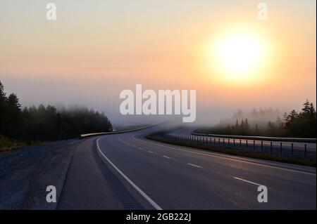 Conceptual image of a asphalt road with view on sunrise Stock Photo