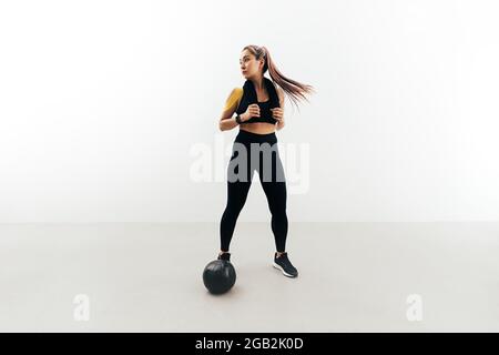 Young woman in sports clothes relaxing after workout indoors Stock Photo