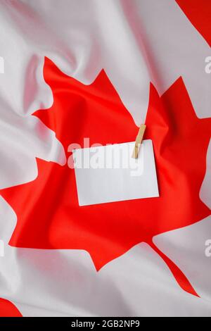 The National Flag of Canada. Canadian Flag or the Maple Leaf with empty paper note Copy space. Tourist traveler or patriotism. International relations Stock Photo