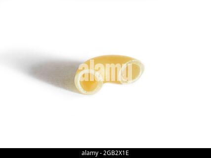 One macaroni isolated on a white background. Macro Stock Photo