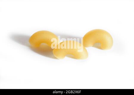 Three macaroni horns isolated on a white background.  Stock Photo