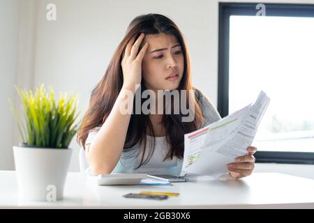 Woman looking worried about bill, No money to paying credit card and debt Stock Photo