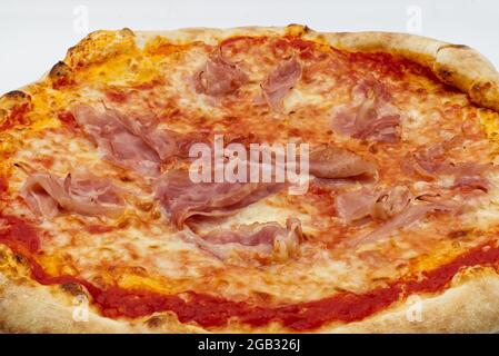 Italian Pizza with mozzarella cheese and ham. Pizza al prosciutto. Close-up Stock Photo
