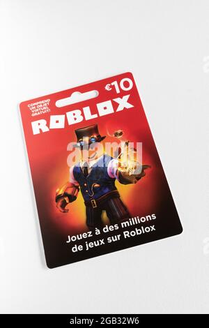 Roblox Gift Card in a Hand Over Gift Cards Background Editorial