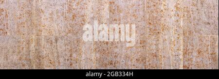 Two rows of large stone tiles with abstract pattern in gray orange brown Stock Photo