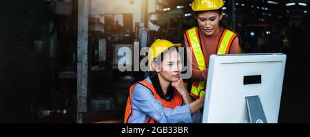 group of Asian engineer team wearing helmet and reflective vest in check and control on computer industry, Stock Photo