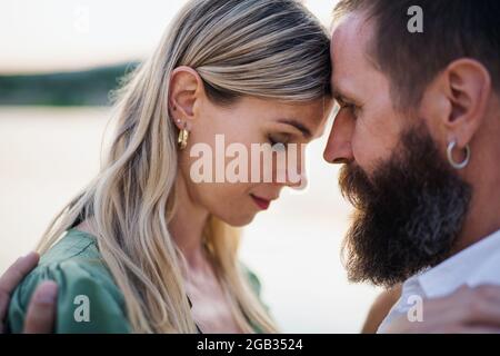 Close-up portrait of happy mature couple in love hugging in nature. Stock Photo