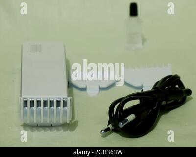 Electronic shaving trimming tool equipment kit presented on white background. Stock Photo