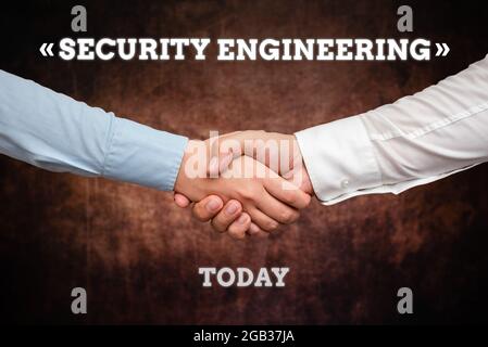 Conceptual caption Security Engineering. Conceptual photo focus on the security aspects in the design of systems Two Professional Well-Dressed Stock Photo