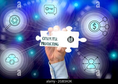 Text sign showing Computer Protecting. Concept meaning protecting computer against unauthorized intrusions Hand Holding Jigsaw Puzzle Piece Unlocking Stock Photo