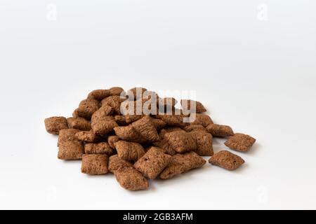heap of chocolate pads isolated on white background, chocolate corn pads, healthy breakfast, side view Stock Photo