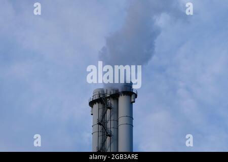 Industrial coal powered electricity plant with pipes and smoke. Ecology problems. Pollution. Chimney smoking. Stock Photo