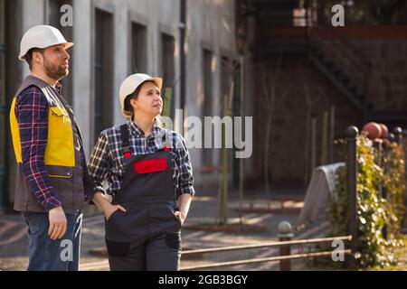 Two young engineers outdoors at the factory Stock Photo