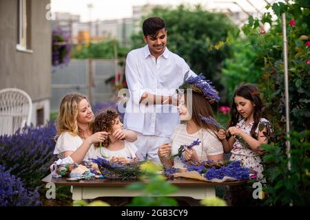 Family time in lavender garden, creative workshop outdoors Stock Photo