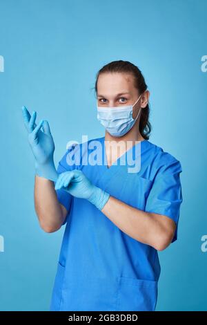 young man doctor in uniform wearing gloves Stock Photo