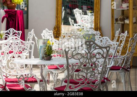 white chairs and tables with red pad in an elegant room at a wedding in the summer Stock Photo